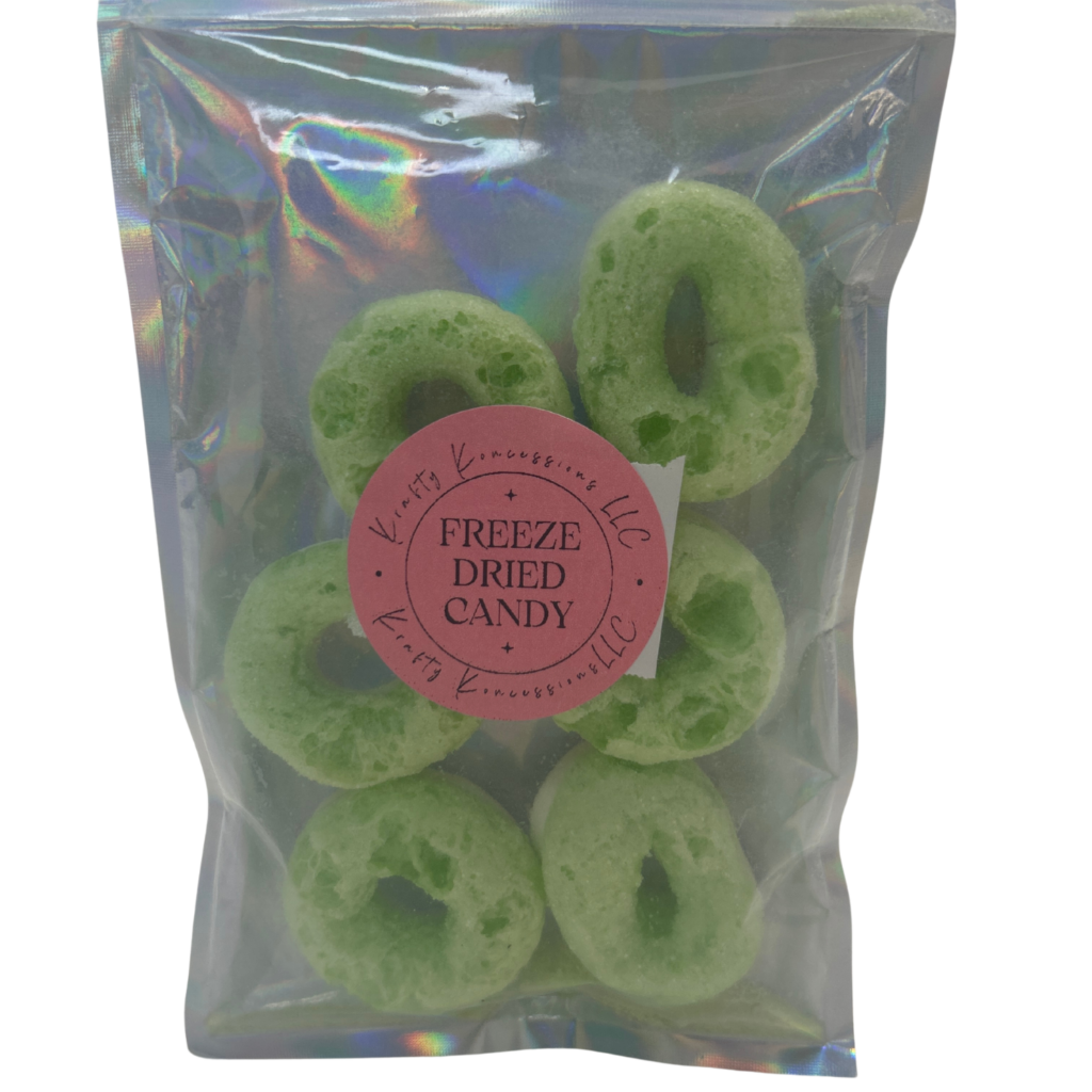 Green colored apple ring freeze-dried candy in silver mylar bags.