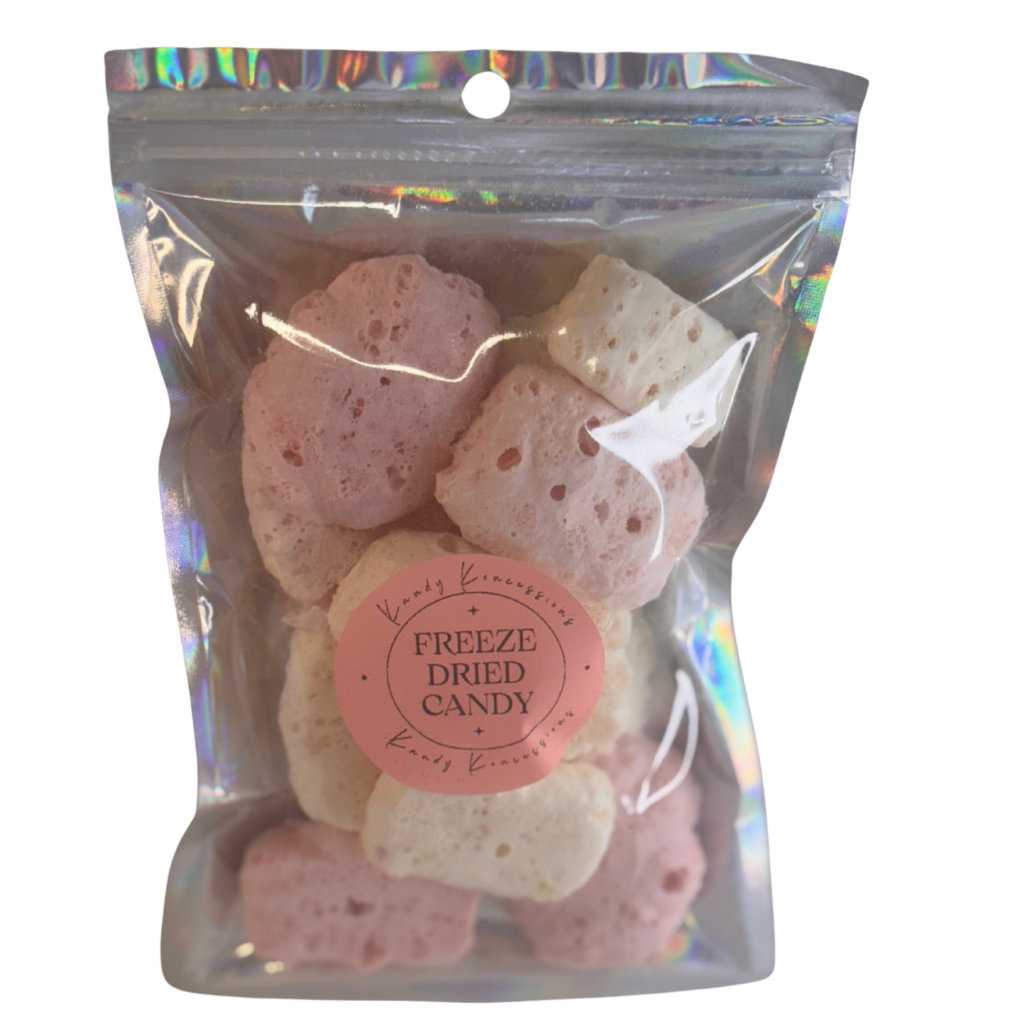 Pink and cream colored candy in a silver backed and clear front mylar bag with a white background.